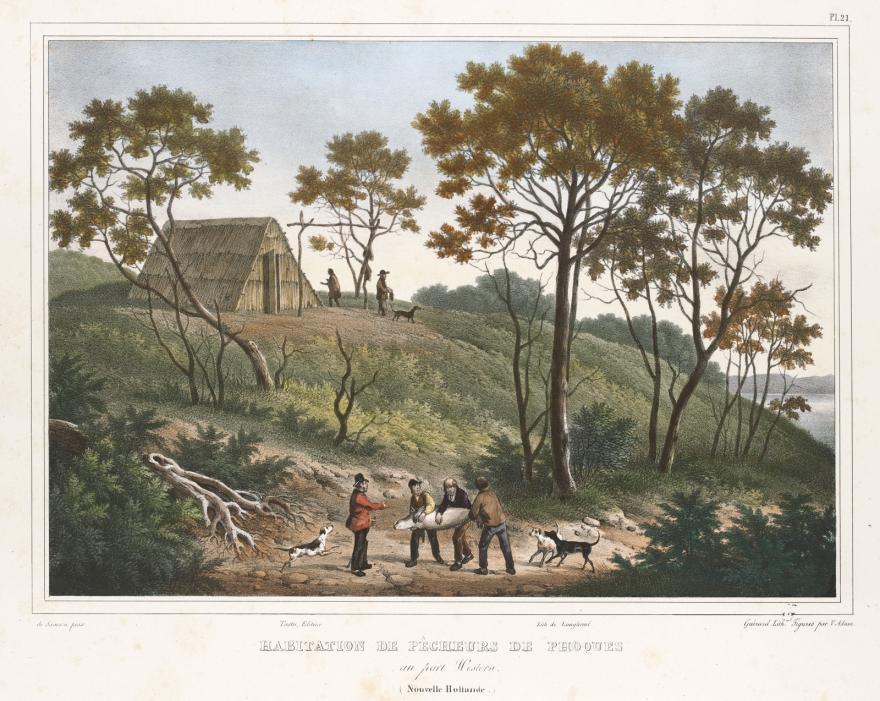 People and dogs on road with trees and hut in background.