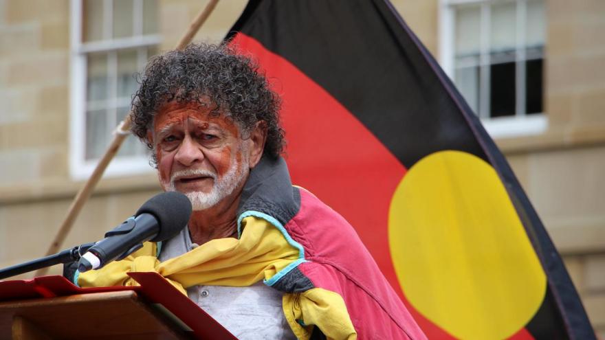 Man with Aboriginal flag behind